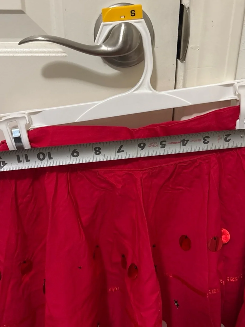 Folclórico Red skirt with white polka dots and green trim, with a white top and